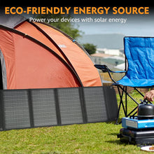 Load image into Gallery viewer, SolarOutside 20W eco-friendly monocrystalline solar panel charger set up at a camping site next to an orange tent and a blue chair. A separate close-up image shows the smart USB output port charging a power bank, illustrating its ability to power smartphones and other USB devices.